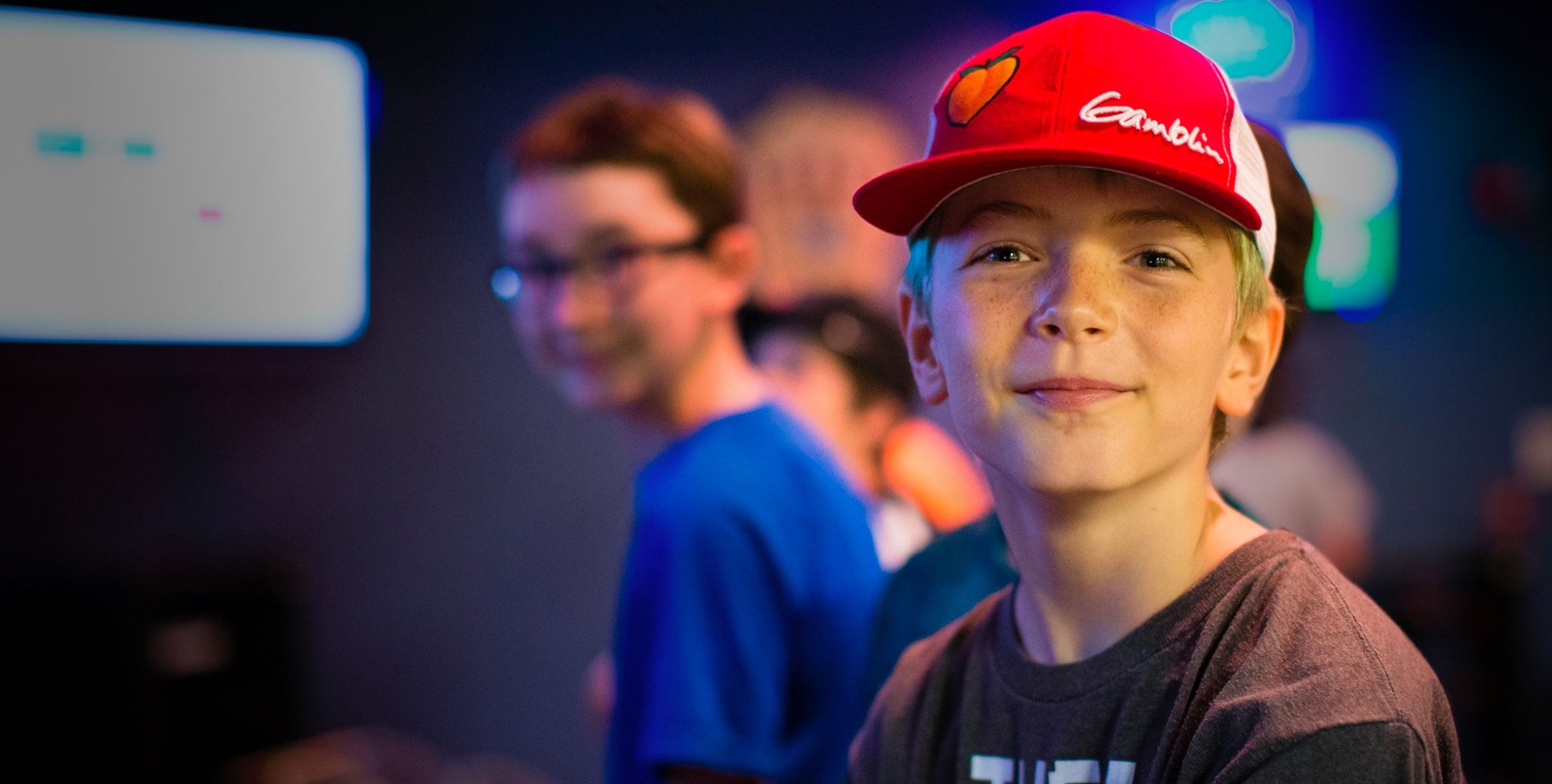 camper smiling, other campers are slightly visible in the background